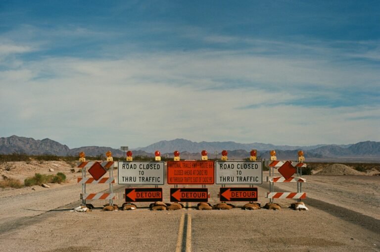 a couple of road signs sitting on the side of a road